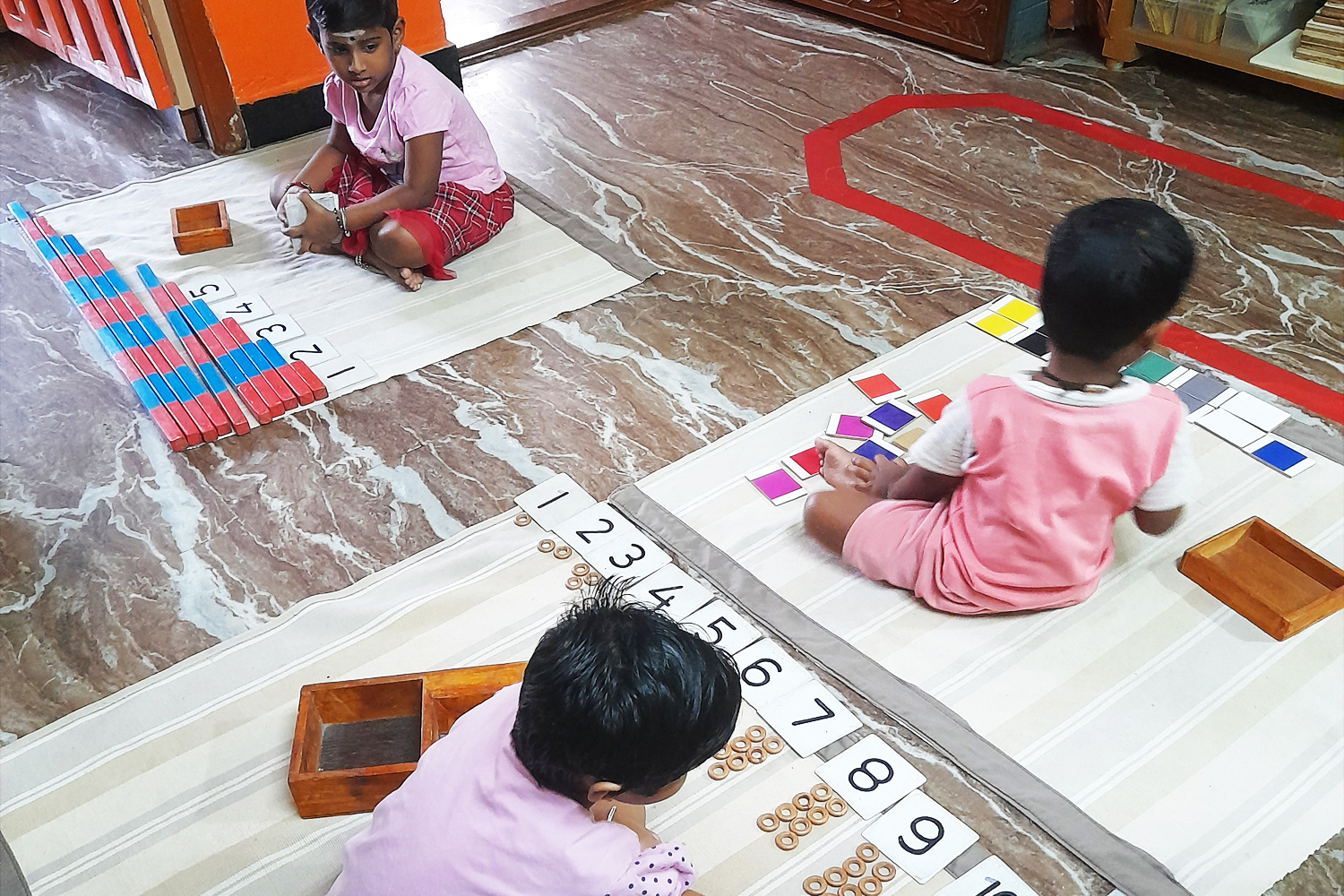 A B Cube Children working with montessori materials 